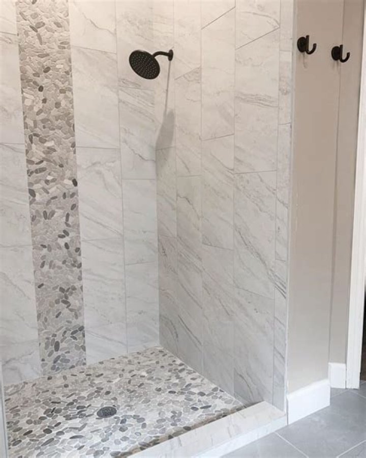 Can you use floor tiles on shower walls?