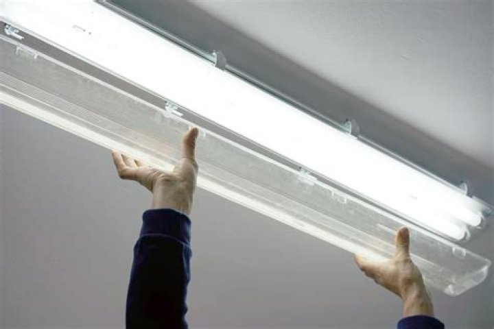 How do you change a fluorescent light lens?
