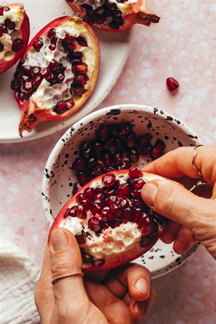 What is the correct way to open a pomegranate?