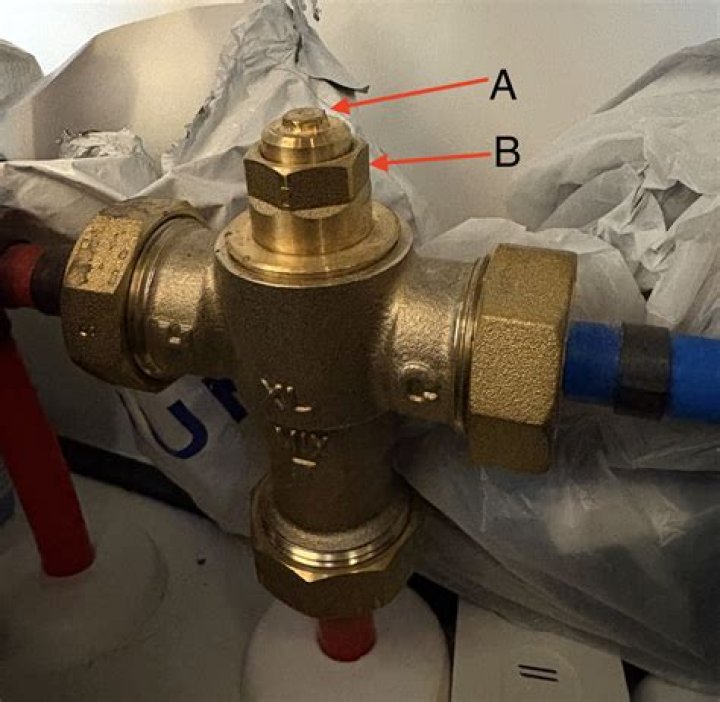 Which way do you turn a mixing valve for hotter water?