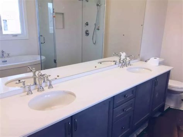 Why are bathroom vanities lower than kitchen cabinets?